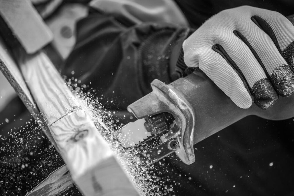 a close up of a saw cutting a 2X4" piece of wood